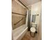 Cozy bathroom features a tiled shower and tub, a toilet, and a stylish towel rack at 3550 S Harlan St # 249, Denver, CO 80235
