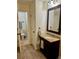 Bathroom featuring a vanity with granite countertop and an adjoining toilet room at 3550 S Harlan St # 249, Denver, CO 80235