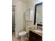Bathroom featuring a vanity with granite countertop and an adjoining toilet room at 3550 S Harlan St # 249, Denver, CO 80235