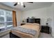 Comfortable bedroom with neutral decor, a ceiling fan and a large window at 3550 S Harlan St # 249, Denver, CO 80235