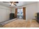 Bedroom features carpet and ceiling fan with a large window with curtains at 3550 S Harlan St # 249, Denver, CO 80235