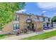 Charming exterior of the townhome with brick accents and beautiful landscaping at 3550 S Harlan St # 249, Denver, CO 80235