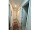 Well-lit hallway showcasing multiple closets and access to various rooms in the home at 3550 S Harlan St # 249, Denver, CO 80235
