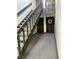Hallway with stairs leading to upper level and two entry doors with door mats and seasonal decorations at 3550 S Harlan St # 249, Denver, CO 80235