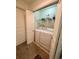 Bright laundry room with washer, dryer, and storage shelves for convenient organization at 3550 S Harlan St # 249, Denver, CO 80235