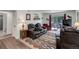 Comfortable living room featuring a leather reclining sofa set and outdoor access at 3550 S Harlan St # 249, Denver, CO 80235