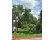 Scenic view of the property with lush greenery, mature trees, and inviting outdoor space at 3550 S Harlan St # 249, Denver, CO 80235