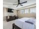 Main bedroom with dresser, ceiling fan, and large windows at 1636 S De Gaulle Way, Aurora, CO 80018