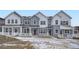 Three-unit townhome building, gray siding, white trim, and front porches at 14556 W 91St Ave # D, Arvada, CO 80005