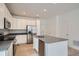 Modern kitchen with white cabinets, gray countertops, and stainless steel appliances at 14556 W 91St Ave # D, Arvada, CO 80005