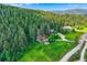 Aerial view of wooded lot, home, and surrounding trees at 8758 S Murphy Gulch Rd, Littleton, CO 80127
