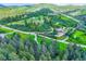 Aerial view of wooded lot, surrounding homes, and roads at 8758 S Murphy Gulch Rd, Littleton, CO 80127