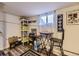 Cozy basement area with a small table, chairs, and decorative sports memorabilia on the walls at 8758 S Murphy Gulch Rd, Littleton, CO 80127