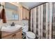 Bathroom with a vanity, toilet, and a shower with a decorative curtain at 8758 S Murphy Gulch Rd, Littleton, CO 80127