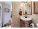 Charming bathroom featuring shiplap walls, a pedestal sink, and a classic framed mirror at 8758 S Murphy Gulch Rd, Littleton, CO 80127