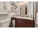 Stylish bathroom with double sink vanity, mosaic tile backsplash, and coordinated white cabinets at 8758 S Murphy Gulch Rd, Littleton, CO 80127