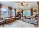 Comfortable bedroom with a patchwork quilt, wood floors, and large windows with scenic views at 8758 S Murphy Gulch Rd, Littleton, CO 80127