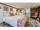 Bedroom featuring a vintage bed frame, a decorative area rug, and relaxing decor at 8758 S Murphy Gulch Rd, Littleton, CO 80127