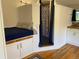 Bedroom with blue accents, built-in cabinets, and adjacent bathroom at 8758 S Murphy Gulch Rd, Littleton, CO 80127