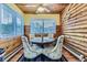 Inviting dining room featuring wood-paneled walls, a round table, and comfortable seating for four at 8758 S Murphy Gulch Rd, Littleton, CO 80127