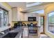 Well-lit kitchen featuring modern appliances, ample counter space, and a view to the outside at 8758 S Murphy Gulch Rd, Littleton, CO 80127