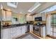 Bright kitchen featuring stainless steel appliances, granite countertops, and a skylight for natural light at 8758 S Murphy Gulch Rd, Littleton, CO 80127