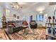 Comfortable living room with vaulted ceilings, large sofa, accent chair, and a decorative rug at 8758 S Murphy Gulch Rd, Littleton, CO 80127