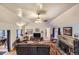 Spacious living room with high ceilings, a stone fireplace, and comfortable seating at 8758 S Murphy Gulch Rd, Littleton, CO 80127