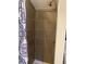 Shower area with tiled walls and a shower curtain with a blue and white design at 8758 S Murphy Gulch Rd, Littleton, CO 80127