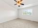 Bright bedroom featuring neutral carpet, a ceiling fan, and a window offering natural light at 1461 S Danube Way # 104, Aurora, CO 80017
