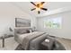 Tranquil bedroom with a ceiling fan, plush bedding, and natural light creating a cozy retreat at 1461 S Danube Way # 104, Aurora, CO 80017