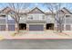 Charming townhome showcasing a well-maintained facade with attached garages and neat landscaping at 1461 S Danube Way # 104, Aurora, CO 80017