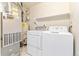 The laundry room includes a washer, dryer, furnace and water heater at 1461 S Danube Way # 104, Aurora, CO 80017