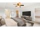 Comfortable main bedroom featuring a ceiling fan and plush bedding, complemented by an inviting walk-in closet at 1461 S Danube Way # 104, Aurora, CO 80017
