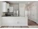 Well-appointed kitchen with a functional bar, leading to a dining area and multiple storage closets at 5863 Sawdust Dr, Brighton, CO 80601