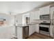 Contemporary kitchen with a stainless dishwasher, and ample countertop space at 5863 Sawdust Dr, Brighton, CO 80601
