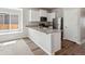Bright kitchen with granite countertops, stainless steel appliances, and a convenient breakfast bar at 5863 Sawdust Dr, Brighton, CO 80601
