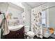 Bathroom includes a shower/tub combo, toilet and vanity at 2469 S Broadway, Denver, CO 80210