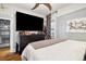 Bright bedroom with large TV, dresser, and closet at 2469 S Broadway, Denver, CO 80210