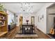 Dining room features a wooden table, unique lighting, and hardwood floors at 2469 S Broadway, Denver, CO 80210