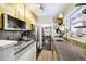 Updated kitchen with gold cabinets and granite countertops at 2469 S Broadway, Denver, CO 80210