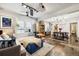 Open living and dining area with hardwood floors and unique light fixture at 2469 S Broadway, Denver, CO 80210