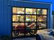 View of shop's garage door, revealing interior and motorcycle at 2469 S Broadway, Denver, CO 80210