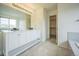Bright bathroom with a dual vanity, white cabinets, and a large mirror at 510 Fairhaven St, Castle Rock, CO 80104