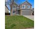 Charming two-story home with well-manicured lawn, gray siding, stone accents, and attached two car garage at 510 Fairhaven St, Castle Rock, CO 80104