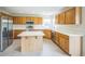 Well-lit kitchen featuring stainless steel appliances, wooden cabinets, an island, and white countertops at 510 Fairhaven St, Castle Rock, CO 80104