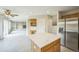 Open kitchen features stainless steel appliances, quartz countertops, center island, and easy access to Gathering room at 510 Fairhaven St, Castle Rock, CO 80104