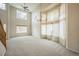 Open floor plan with vaulted ceilings, large bright windows, neutral carpeting and elegant light fixture at 510 Fairhaven St, Castle Rock, CO 80104