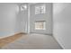 Spacious living room with high ceilings, multiple windows, neutral carpet and paint, and a wooden floor entry at 510 Fairhaven St, Castle Rock, CO 80104