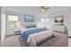 Bright main bedroom with large bed, blue accents, multiple windows, and modern decor at 510 Fairhaven St, Castle Rock, CO 80104